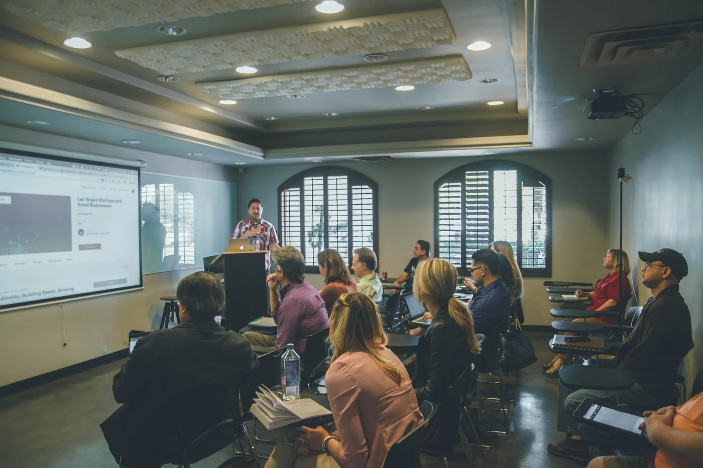 A class during a lesson: the teacher at the board and the students following from their desks